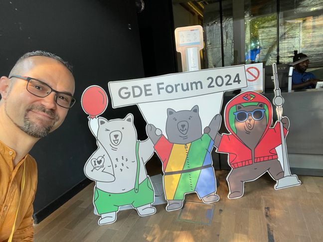 Me at the entrance of the GDE forum Belin at Google Offices, with bears on top of the logo